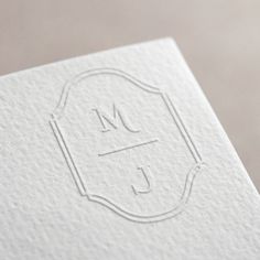 the letter j is inscribed in white paper