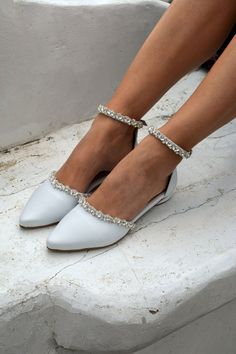 a close up of a person wearing white shoes