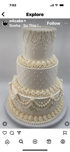 a three tiered cake with white icing and beading on the top layer