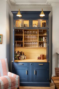 a blue cabinet with wine glasses in it