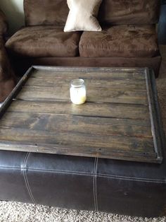 a coffee table with a candle on it