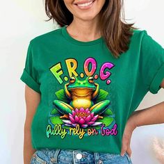 a woman wearing a green frog t - shirt with the words frog and lily on it