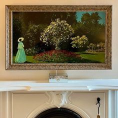 a painting hanging on the wall above a fireplace with a woman in a green dress