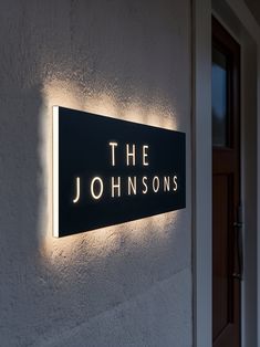 the sign on the side of a building that says, the johnsons in illuminated letters