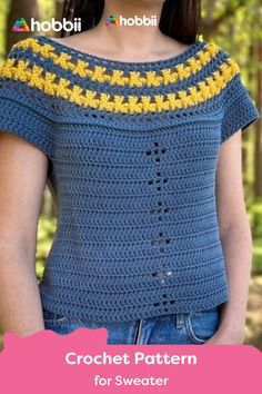 a woman wearing a blue crochet top with yellow flowers on the side and text overlay that reads, crochet pattern for sweater