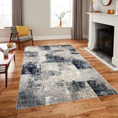 a living room with wood flooring and a rug in front of a fire place