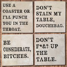 four coasters with words on them sitting next to each other in front of a wooden table