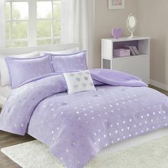 a purple bed with hearts on it