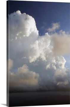 an airplane is flying in the sky with clouds