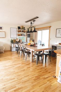 an open kitchen and dining room with hardwood floors