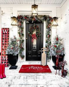 a front door decorated for christmas with wreaths and decorations