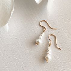 "This beautifully simple pair of dangle earrings are lovingly handmade with eight tiny Freshwater Pearls and a choice of a 14k Solid Gold, 14k Gold Filled, 14k Rose Gold Filled or Sterling Silver finish. M A T E R I A L S: * Freshwater Pearl  * 14k solid Gold, 14k Gold Filled, 14k Rose Gold Filled or Sterling Silver S I Z E: *  Gemstone - Approximately 3-6mm All of our jewellery is carefully handmade using good quality materials and handpicked gemstones, with the aim to produce quality pieces that you can love & wear for years to come.  P E A R L: * June Birthstone * Talisman for Gemini, Cancer * Third Eye Chakra Pearl signifies faith, charity and innocence. It enhances personal integrity and helps to provide a focus to ones attention. Pearl symbolises purity and is known as a \"stone of s Tiny Pendant Necklace, Pearl Jewelery, Pink Gemstone Necklace, Drop Earrings Simple, Dangle Earrings Silver, Tiny Pendant, Gemstone Drop Earrings, White Jewelry Box, Pearl Dangle Earrings