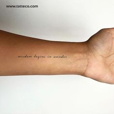 a person's arm with a tattoo that reads random things on wonder