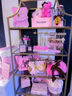 a display case filled with lots of pink and gold items on top of a shelf