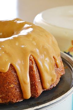 a bundt cake covered in frosting on top of a pan