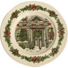 a christmas plate with an image of a house and wreaths on the front side