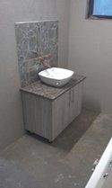 a white sink sitting next to a bath tub in a bathroom