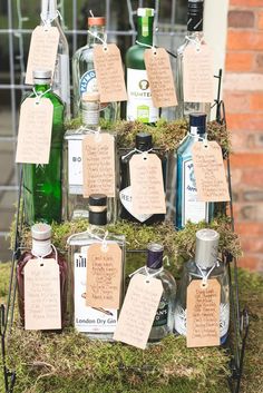 a display with lots of bottles and tags on it's sides, sitting in the grass