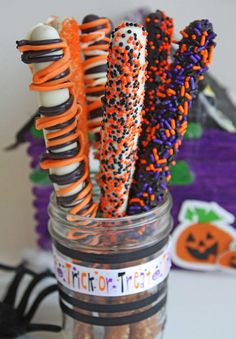 halloween candy sticks in a jar with sprinkles