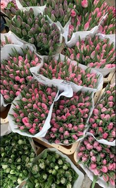 pink and white flowers are arranged in baskets