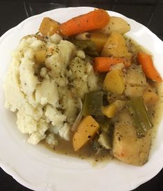 a white plate topped with mashed potatoes and veggies