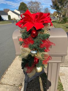 a mailbox decorated with christmas decorations and bows