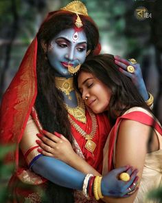 two women hugging each other while dressed in costume and makeup for the occasion of holi day