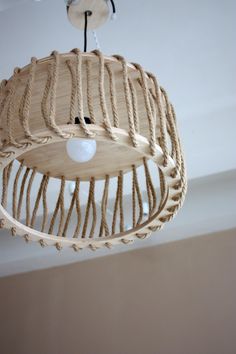 a wooden light fixture hanging from the ceiling