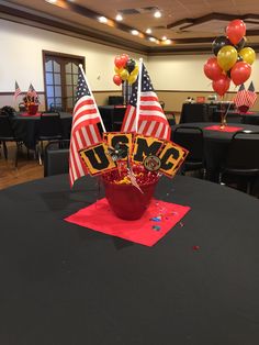 an american flag centerpiece sits on top of a black table in a banquet hall