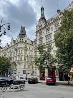 an old building with cars parked on the street