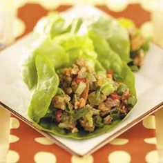 lettuce wraps filled with meat and vegetables on a plate