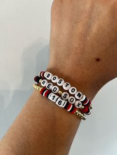 ⚾BASEBALL SEASON IS HERE If you are a Boston Red Sox fan, what better way to support your team than with one of these bracelets?  ⚾These trendy bracelets are the perfect gift for a teacher, girlfriend, wife, friend, and yourself!  Buy one bracelet or buy all three to create a stack.   ⚾Bracelets are made with 4mm gold plated round beads, 7mm acrylic round alphabet beads, 6mm heishi disc beads, and square number beads. ⚾️For Number Bead Bracelet orders, please click on the "Personalization" box to enter the Jersey Number you want for your bracelet. ⚾Bracelet Care: *Roll bracelets on and off. *String is stretchy elastic. Please be mindful not to stretch too much. *Keep bracelets dry and away from fragrance sprays/soaps. *Bracelets will come in secure plastic packaging. Feel free to keep brac Keep Bracelet, Baseball Bracelet, Number Beads, Stack Bracelets, Red Socks Fan, Bracelets Ideas, Red Sox Baseball, Sports Bracelet, Trendy Bracelets