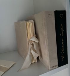 an open book sitting on top of a white shelf