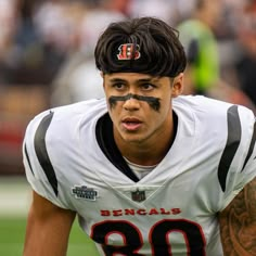 a close up of a football player with his face painted