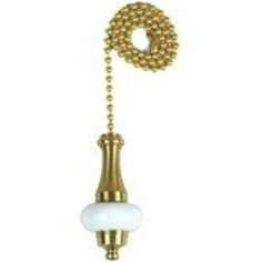 an old fashioned telephone is hanging from a gold chain with a white bead ball on it