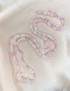 "Made to order clear, white, & pink glass beads with rose quartz crystals ✨ Removable and adjustable up to 2\" with a choice of silver or 14k gold clasp.   In the notes please include what length you would like your beads! Measure your waist wherever you want your beads to fall as shown in the listing photo. Rose Quartz 🌹💖 is associated with the heart chakra and is a stone for universal & unconditional love of the self and others. Custom waist beads are available through message or DM on Instagram! Chakra: Heart All crystals are charged under moonlight of the new moons and cleansed with palo santo before they are mailed." Pink And White Waist Beads, White Adjustable Crystal Necklaces With Round Beads, Adjustable White Crystal Necklaces With Round Beads, White Beaded Necklaces For Valentine's Day, Valentine's Day White Beaded Necklaces, Adjustable White Crystal Necklace With Faceted Beads, White Crystal Necklaces With Heart Shaped Round Beads, White Crystal Necklace With Faceted Beads And Adjustable Fit, Adjustable White Rose Quartz Jewelry