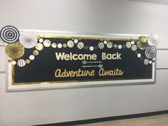 a welcome back sign is hanging on the wall