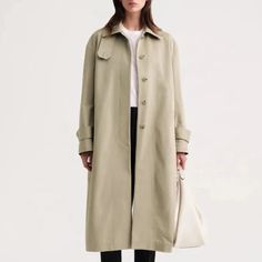 Elevate your outerwear with the TOTEME Signature trench khaki. Crafted from durable cotton, this long coat exudes a vintage classic vibe. With a stand collar and long version, stay warm and stylish in any weather. A must-have for fashion-forward individuals. Women's Windbreaker, Classic Vibe, Effortless Outfit, Detachable Collar, Long Trench, Long Trench Coat, Long Sleeves Coats, Trench Coats Women, Clothing Essentials