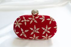 Red Clutch Designer made for Weddings w/ Minimal Zardozi Minimal clutch adorned with simple floral zardozi, bead & sequin embellishments. This red clutch purse evening -wear with a stone-studded closure at the top is a must-have in your wardrobe - a versatile accessory for any party outfit!  Lining: Fabric Color: Red Embroidery: Zardozi, Sequin & Bead Size & Dimensions:  Height - 5 in Width - 8 in Depth - 1.5 in Fits most of the phones. Strap: Detachable shoulder metal chain strap  Closure: Comp Elegant Hand Embellished Party Bags, Elegant Hand Embellished Evening Bag For Events, Glamorous Hand Embellished Evening Bag For Formal Events, Embellished Pouch Evening Bag As Gift, Embellished Pouch Evening Bag For Gift, Glamorous Red Evening Clutch, Red Embellished Evening Bag, Elegant Festive Evening Bag As Gift, Red Embroidered Clutch For Festive Occasions