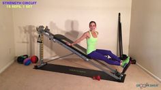 a woman is sitting on a rowing machine