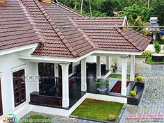 a white house with red tile roofing and green grass