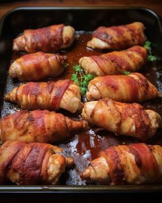 bacon wrapped chicken on a baking sheet ready to be cooked