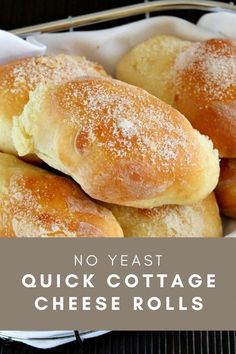 some bread rolls are in a basket with powdered sugar on top and the words, no yeast quick cottage cheese rolls