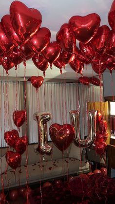 red balloons with the word i love you hanging from them