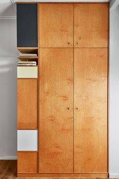 an empty room with wooden cabinets and white walls