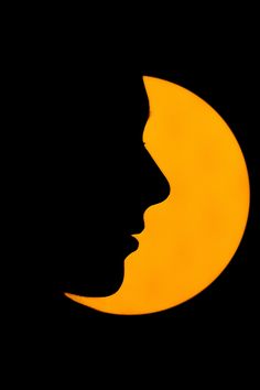 a woman's face is silhouetted against the backdrop of a yellow crescent moon