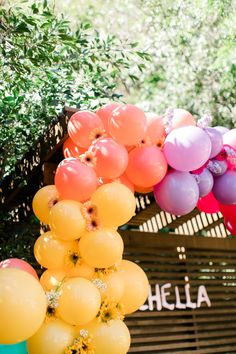 there are many balloons hanging from the ceiling