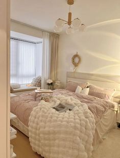 a bedroom with a large bed covered in fluffy blankets