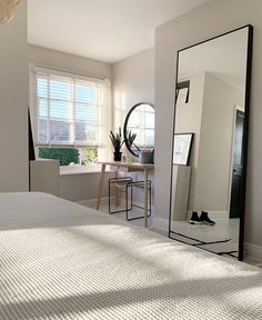 a bedroom with a large mirror on the wall