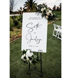 a sign that says welcome to the bride and groom on it in front of some chairs